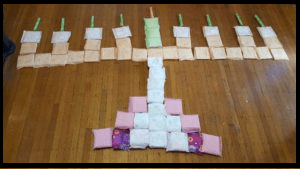 Maxi pads and tampons arranged to look like a menorah